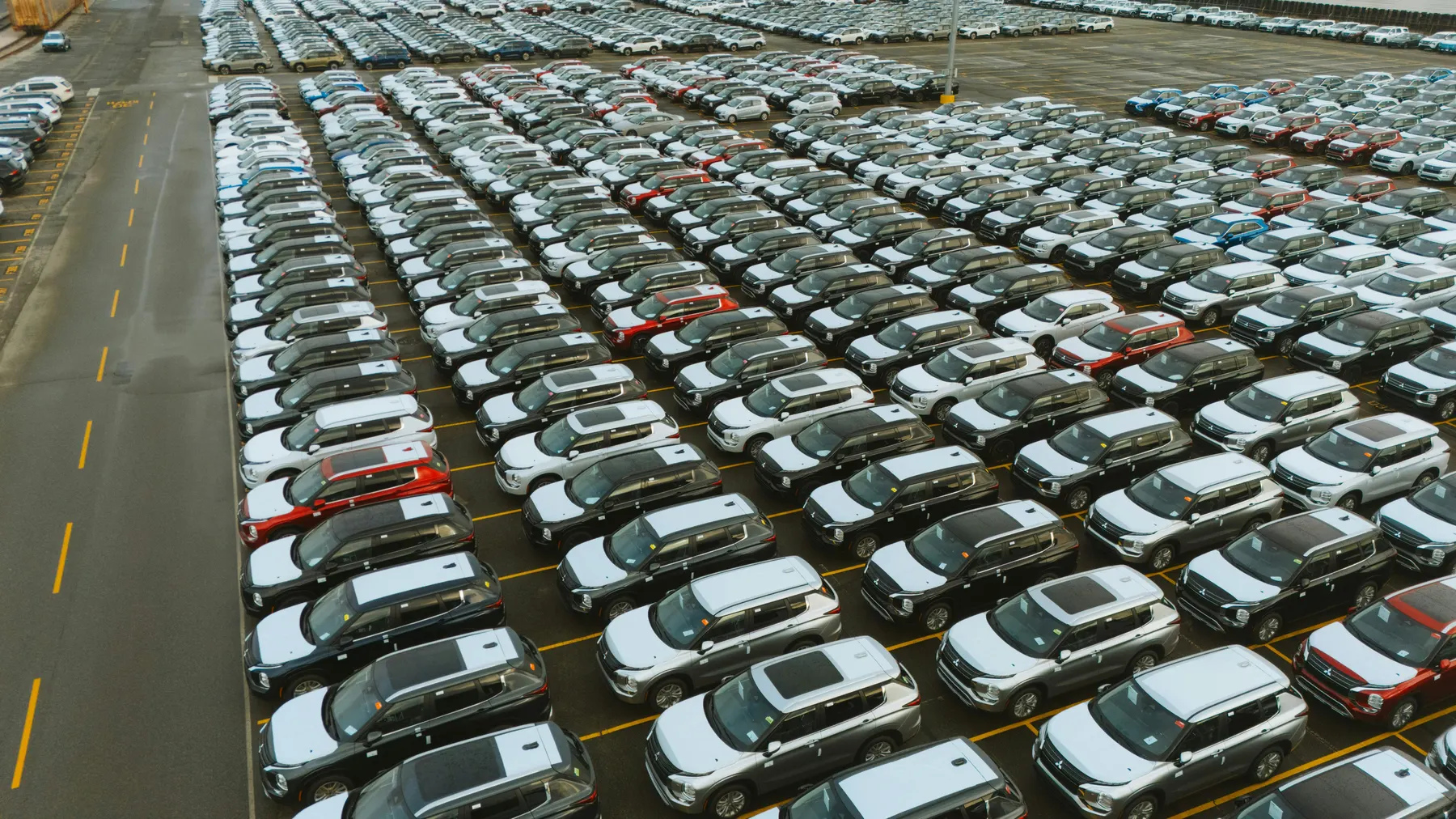 Large Chinese automotive factory export yard with hundreds of vehicles