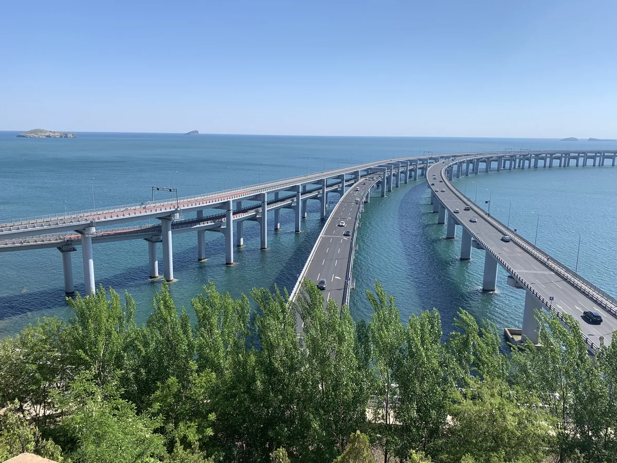 View of Dalian city skyline and bridge from the rocks
