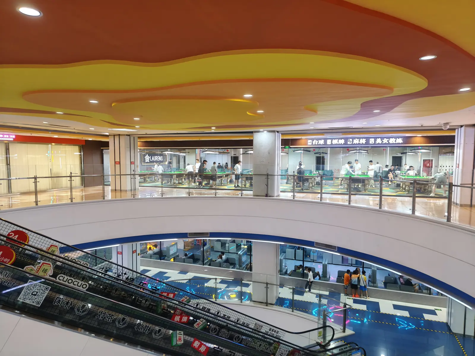 Pool tables next to PlayStation booths in a Chinese mall