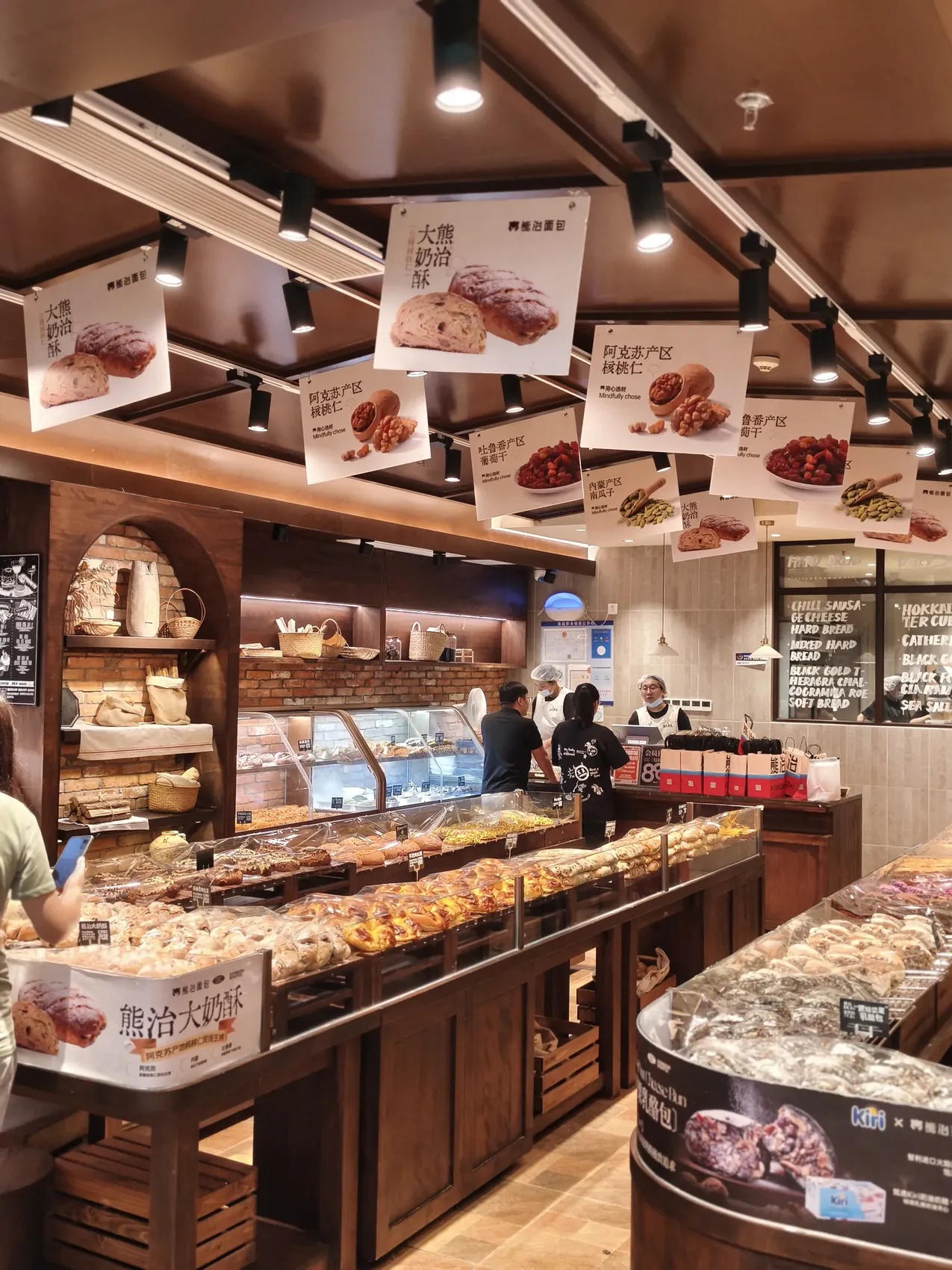 Western-style supermarket bakery in Shanghai with hanging photo cards showing ingredient origins