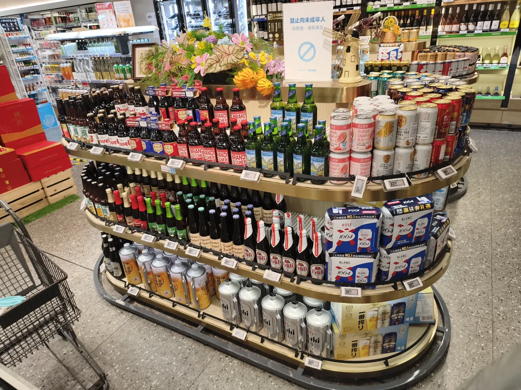 Supermarket display island of Belgian, German and Japanese beers alongside Chinese brands