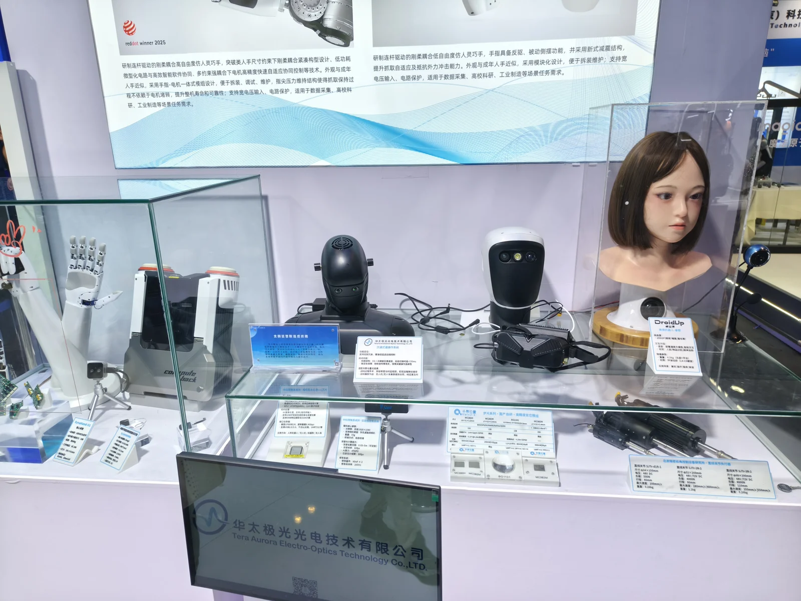 Display case of robotic components including humanoid hands, heads and sensors
